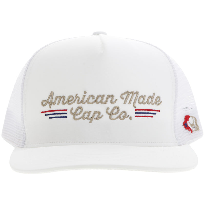 the front of American Made Cap Co hat in white with red, blue, and gold embroidered details