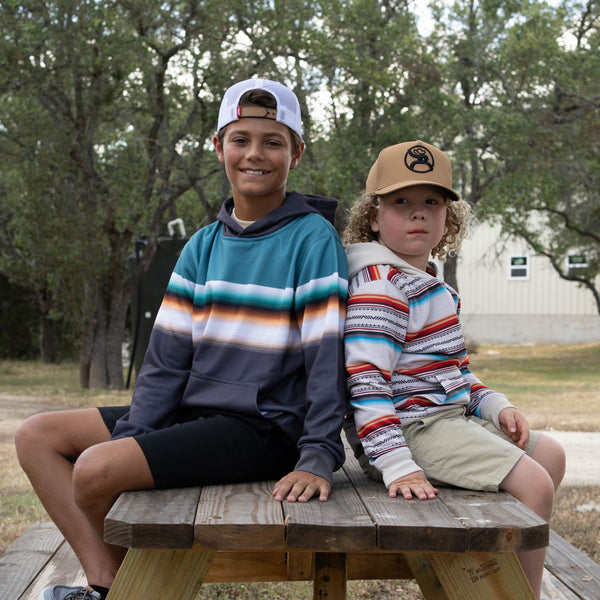 youth model posing in Hooey gear at the camp ground