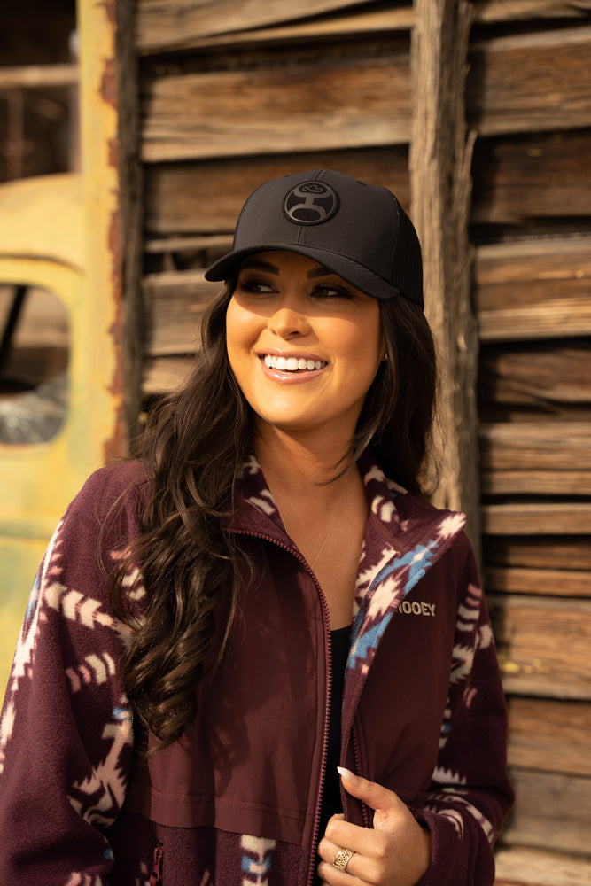 female model wearing black cap with maroon jacket