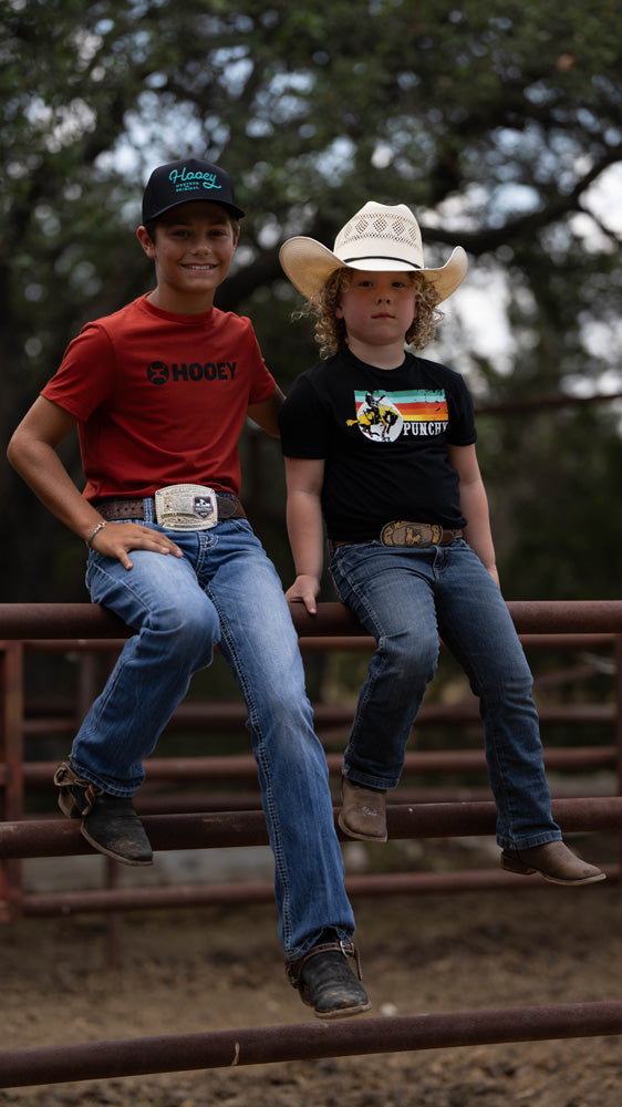 youth models posing on pipe fence in 2024 Hooey gear