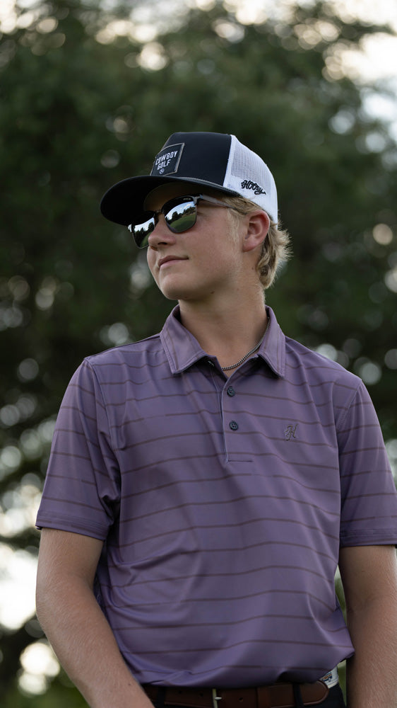 male model wearing purple with grey stripe polo