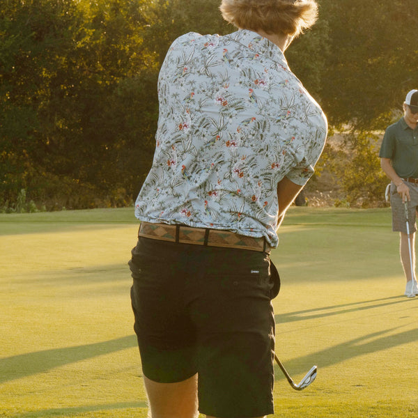 The back of a model playing golf in hooey golf gear