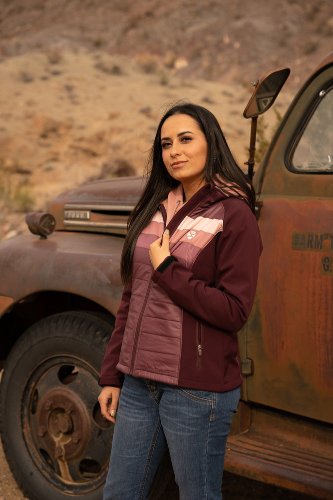 female model wearing blue jeans, burgundy, purple, orange, pink puffer jacket 