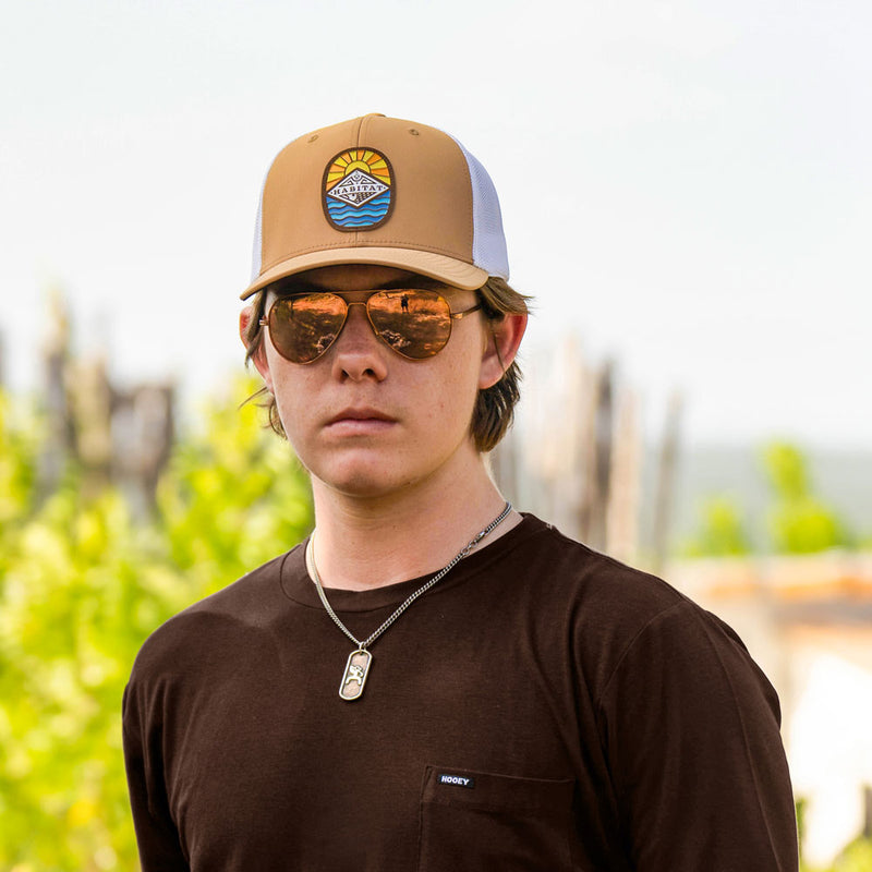 tan and white Habitat hat and brown hooey tee worn by model