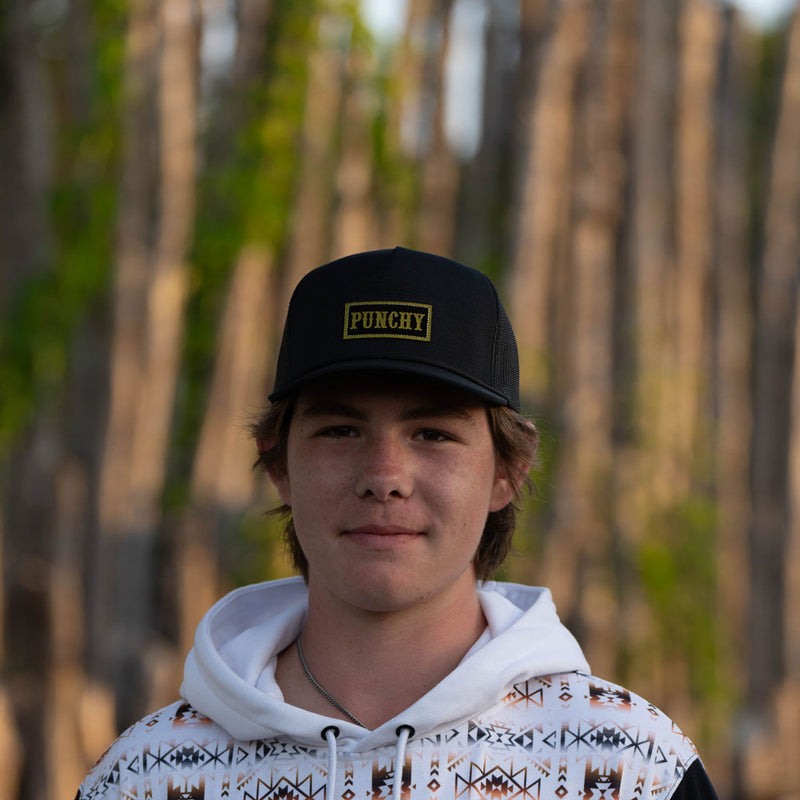 black and gold punchy hat worn by male model