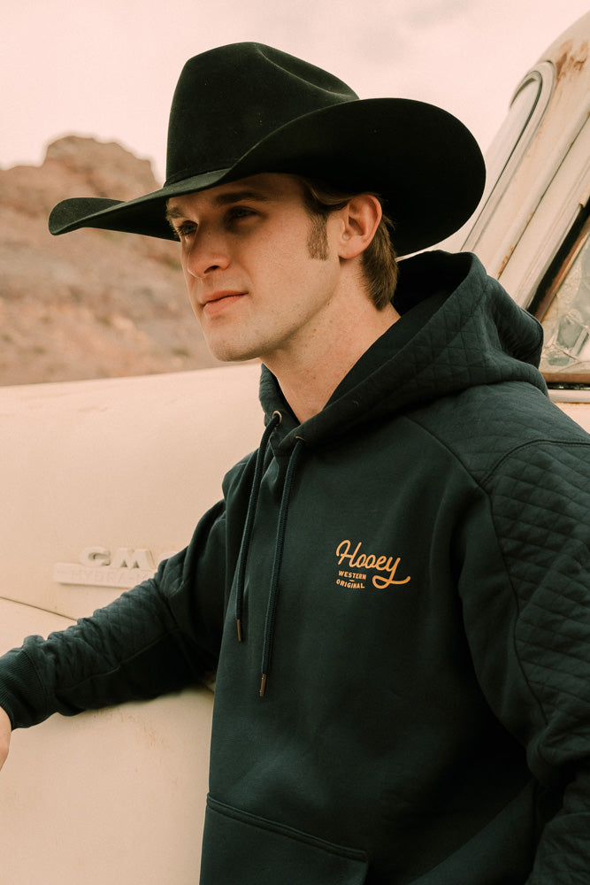 profile image of model wearing navy with gold logo hoody