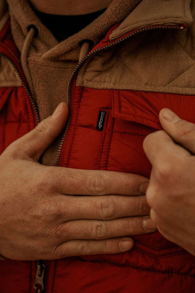 Close-up of red and brown puffer jacket