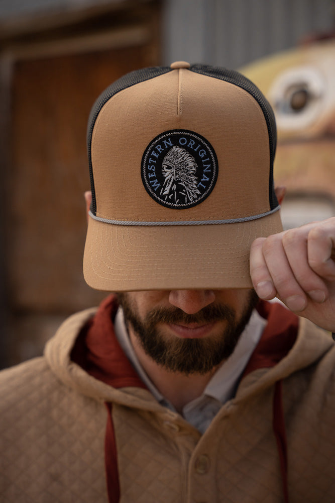 male model wearing tan and rust quilted hoody with tan and black western original cap