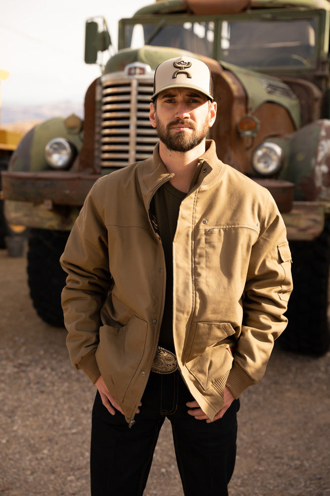 male model wearing the Hooey cargo Jacket in tan with brown Aztec pattern lining