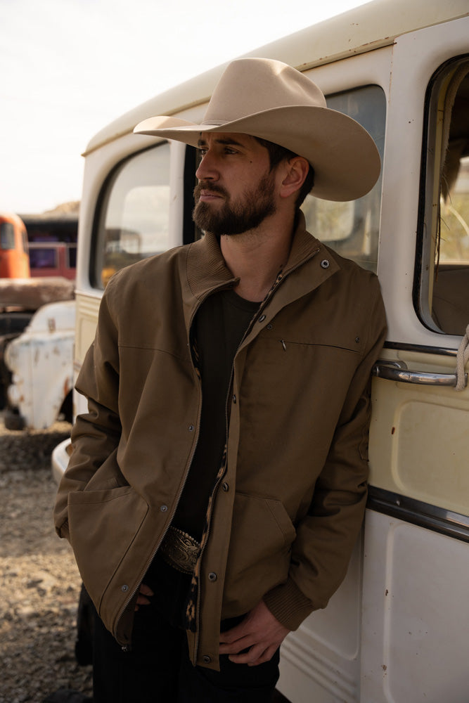 male model wearing the Hooey cargo Jacket in tan with brown Aztec pattern lining