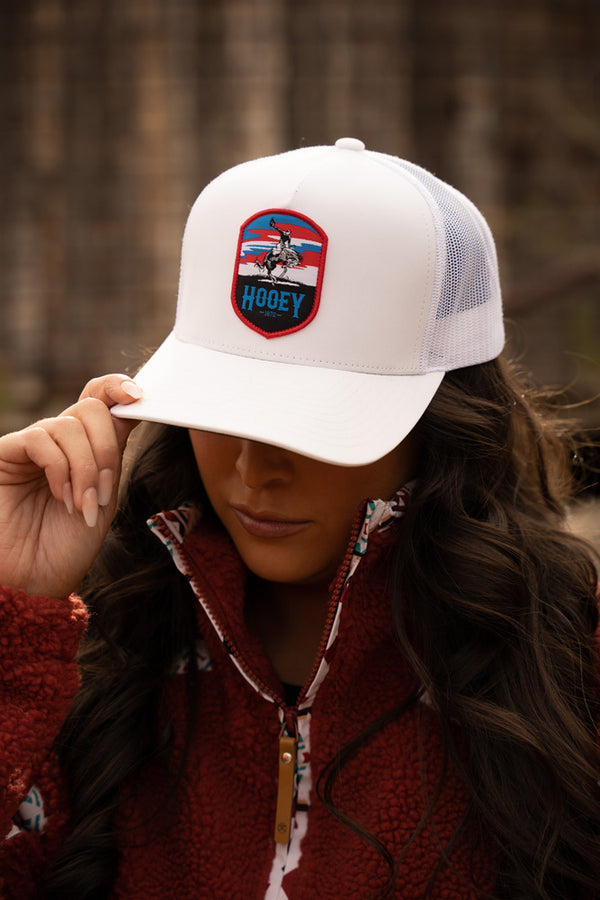 female model wearing red fleece zip up jacket with white Cheyenne hat 