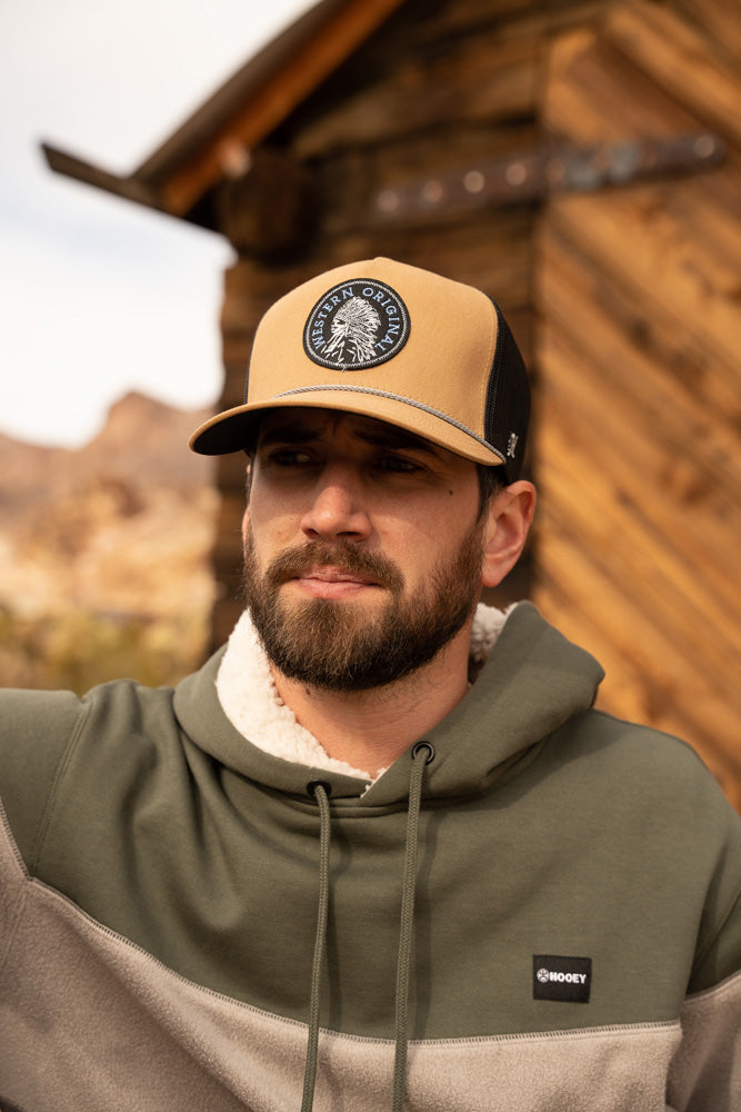 Close up image of a male model wearing the Breck olive, grey, charcoal hoody