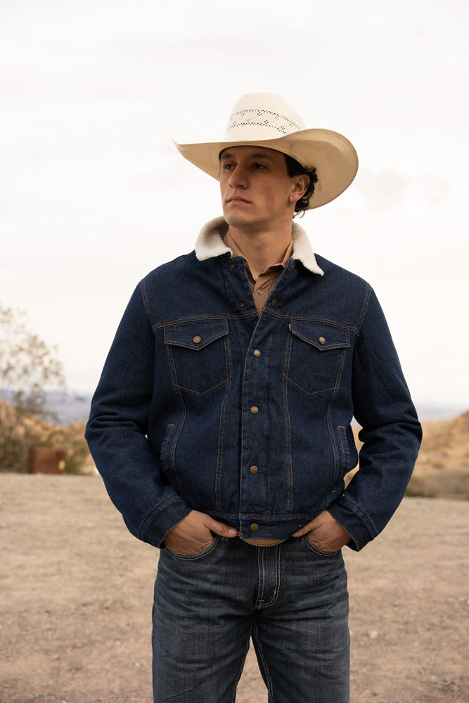 male model wearing the Hooey Denim Jacket in blue with cream sherpa lining