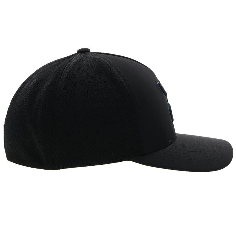 right side of the black on black Coach flexfit hat with charcoal logo