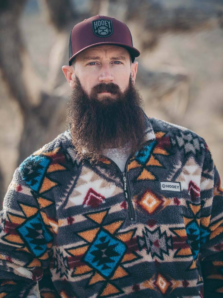 male model wearing the Hooey Fleece Pullover brown, red, yellow, turquoise Aztec pattern