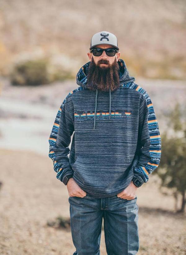 model wearing Canyon navy hoody with yellow, orange, light blue serape pattern